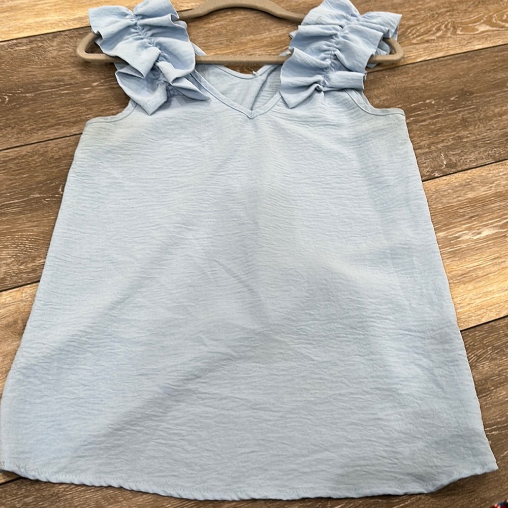 Light blue tank top with ruffled sleeves! It is in great condition!!